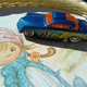 Illustration for article titled Just some bored dude taking pics of crappy diecasts at a boring yard sale...